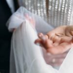 beautiful-bride-holds-wedding-ring (1)